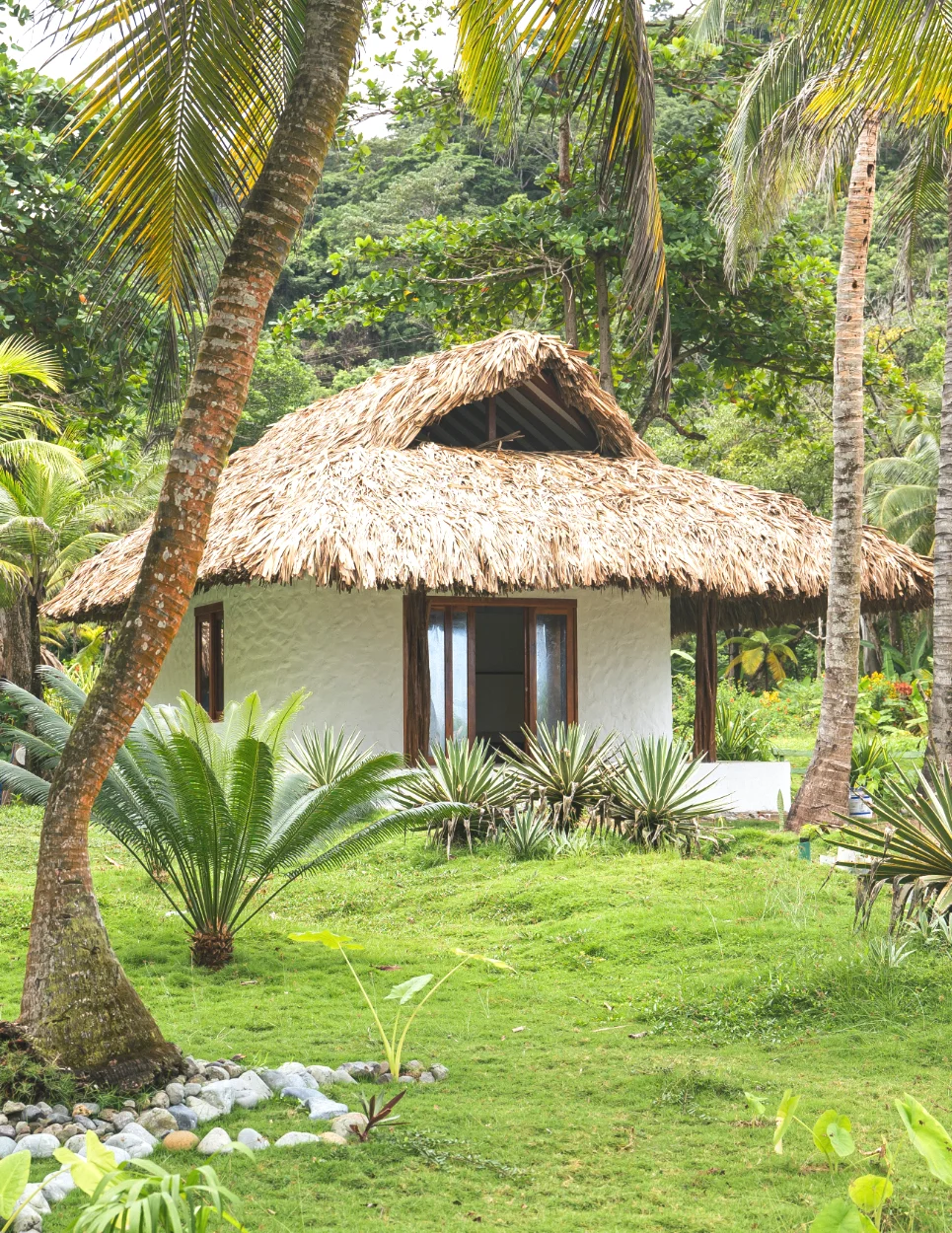 Eco Bungalow Eco-friendly bungalow surrounded by tropical gardens at Brisa Bahía retreat center.