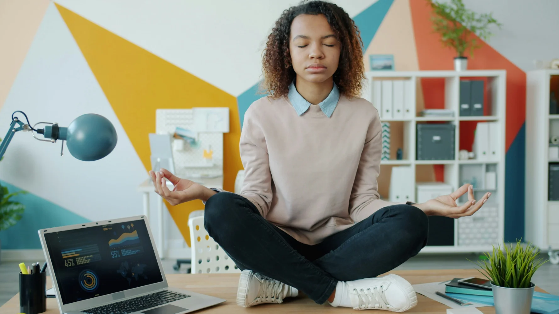 Person practicing mindful productivity with meditation in calm minimalist workspace